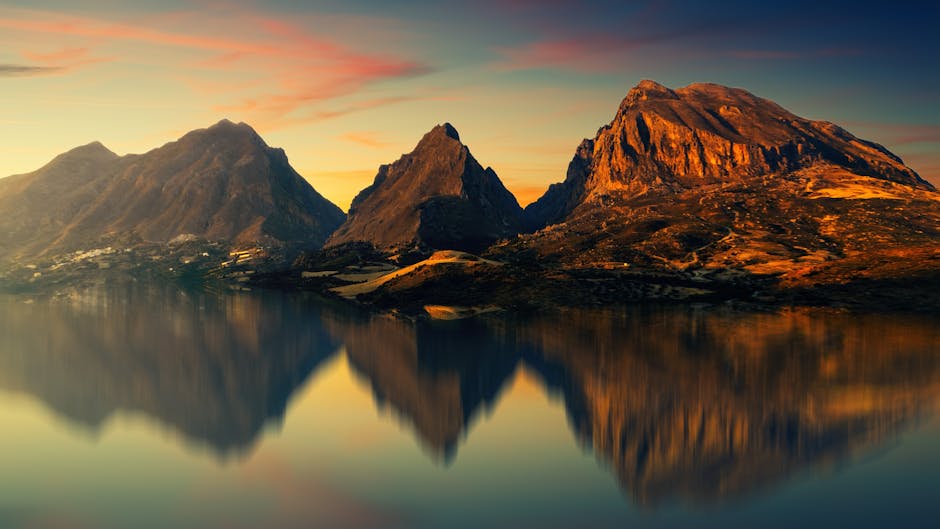 Jagged mountains reflected in still lake water